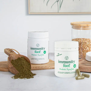 Immunity fuel supplement containers with a scoop of powder on a light background